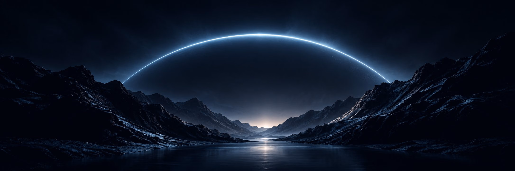 An arc of light over a dark mountain valley