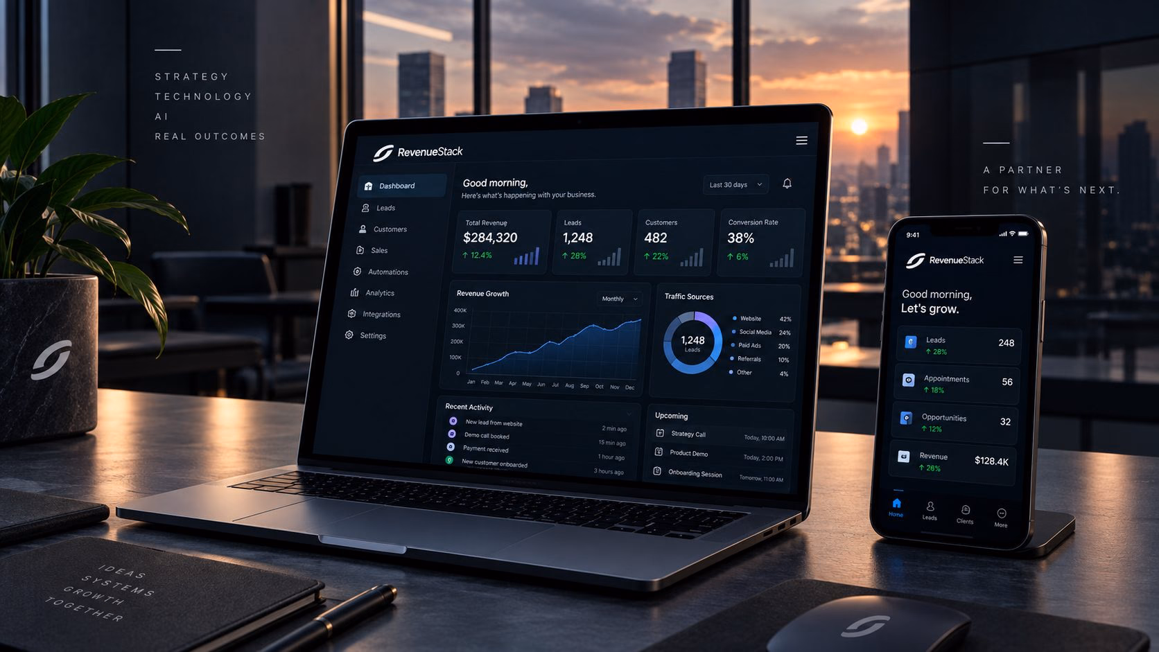 A laptop and phone showing RevenueStack dashboards on a desk at sunset