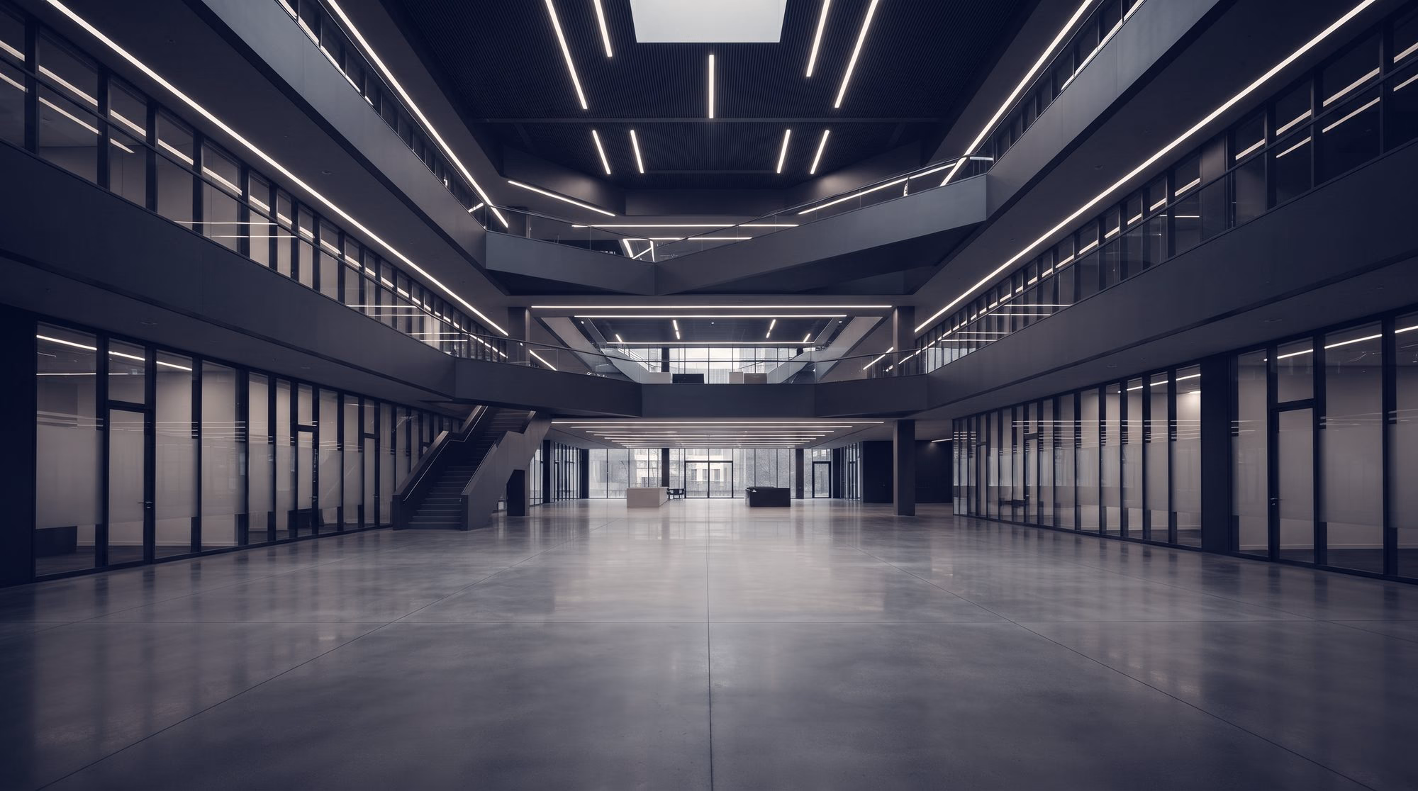 A large concrete hall lit by rows of overhead lights