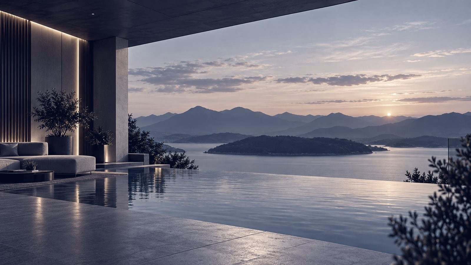 An infinity pool at sunrise looking out over calm water and distant islands