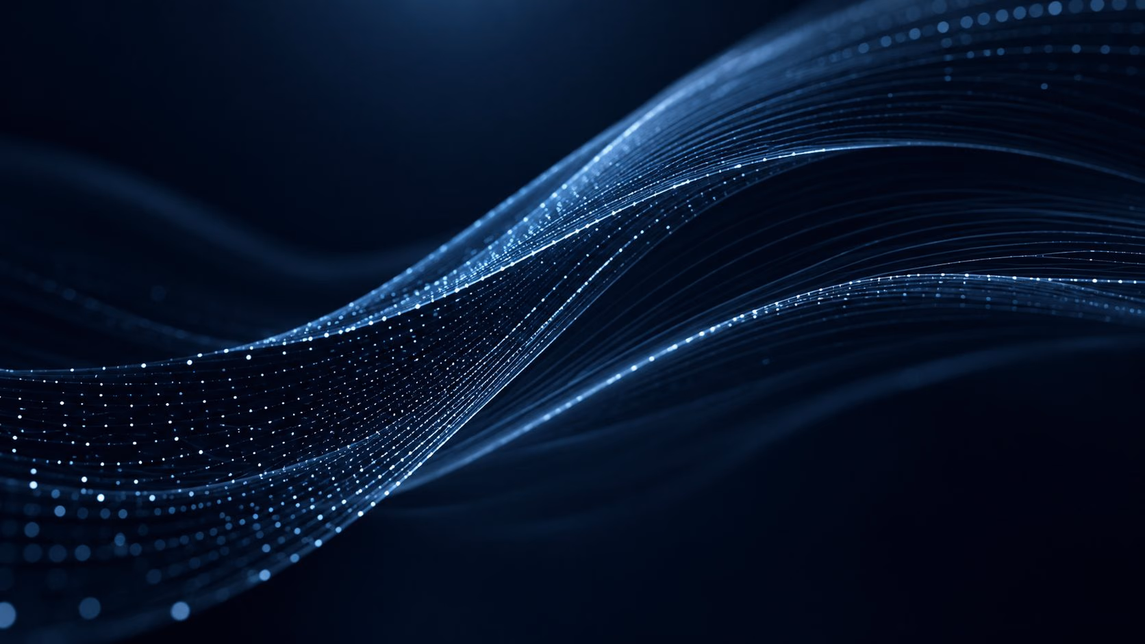 A wave of glowing blue particles flowing across a dark background